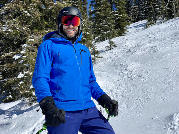 This photo shows the author wearing the Helly Hansen Odin 9 Worlds 2.0 Jacket on a ski hill during the review process.