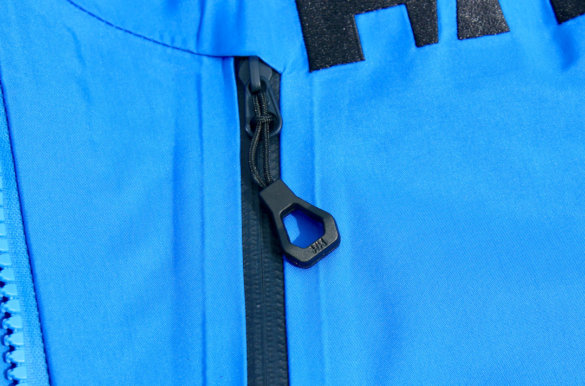 This photo shows a closeup of the Helly Hansen Odin 9 Worlds 2.0 Jacket zipper pulls.