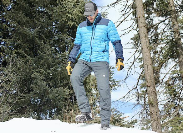 This photo shows the author wearing the Eddie Bauer Guide Pro Pants in the winter on a snowy hill during the review process. 
