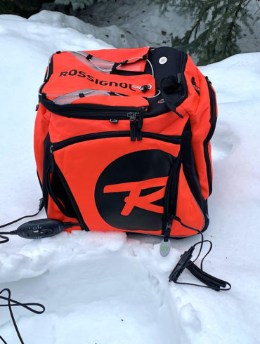 This review photo shows the Rossignol Hero Heated Boot Bag outside on a snowbank.