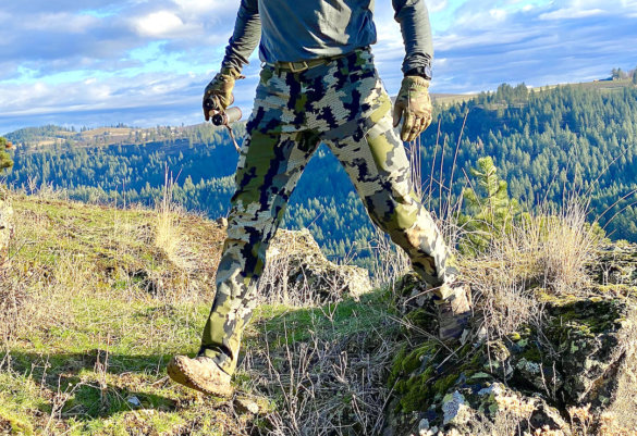 This photo shows the author wearing the KUIU Attack Pants while stepping to illustrate the 4-way stretch fabric.