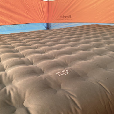 This photo shows the REI Co-op Kingdom Insulated Air Bed inflated inside of a camping tent during the testing and review process.