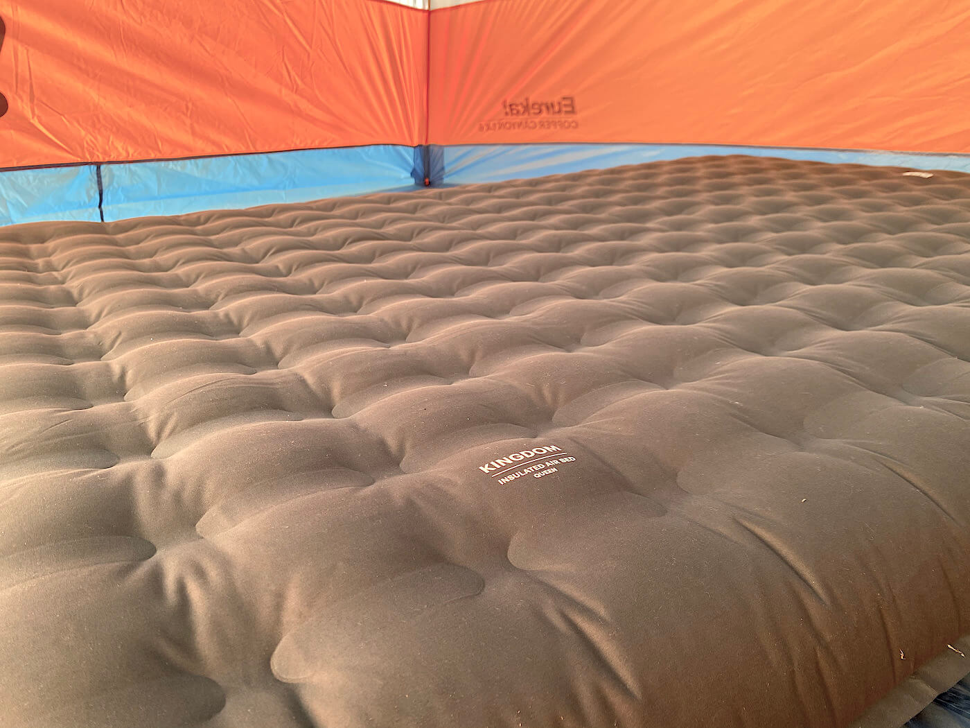 This photo shows the REI Co-op Kingdom Insulated Air Bed inflated inside of a camping tent during the testing and review process.