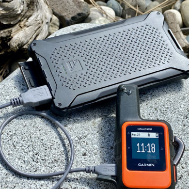 This photo shows the Dark Energy Poseidon Pro Charger charging a Garmin InReach Mini satellite messenger device.