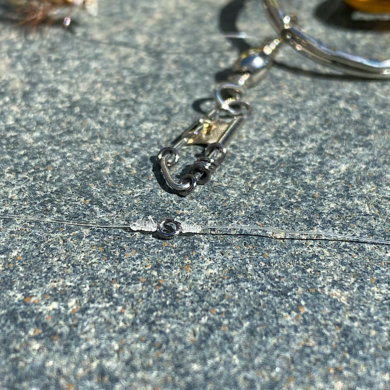 This photo shows a tippet ring attached to a fly fishing leader and tippet as well as tippet rings on a snap swivel.