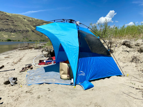 This photo shows the L.L.Bean Sunbuster Folding Shelter set up on a sunny beach.