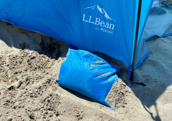This photo shows the L.L.Bean Sunbuster Folding Shelter sandy anchor pockets.