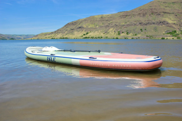 This photo shows the 15' ISLE Megalodon 2.0 paddle board floating on a lake.