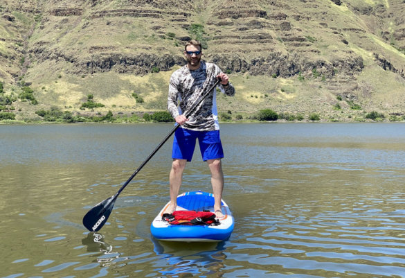 This photo shows the author testing the Ascend iSUP paddleboard on the water.