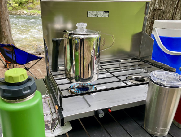 This photo shows the GSI Pinnacle Pro Camp Stove on a camp table during the testing and review process.