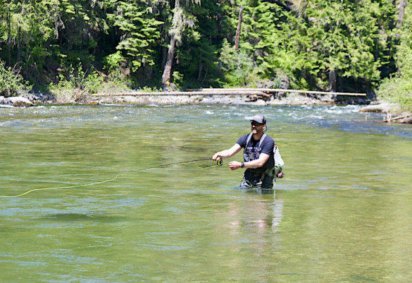 This image shows the author fly fishing in a river while testing the L.L.Bean Quest Fly Rod Outfit during the review process.