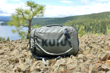 This photo shows the KUIU Waypoint 2800 Duffel outside near a forest and lake during the testing and review process.