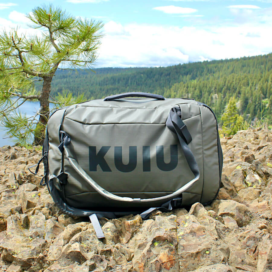 This photo shows the KUIU Waypoint 2800 Duffel outside near a forest and lake during the testing and review process.