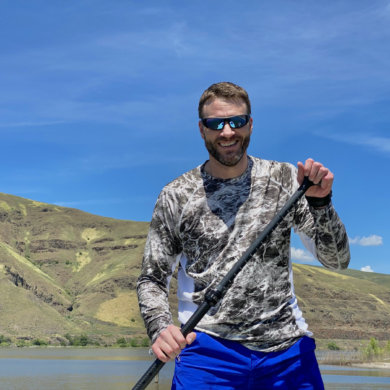 This photo shows the author wearing the L.L.Bean Tropicwear Knit Crew Shirt while standup paddle boarding during the testing and review process.