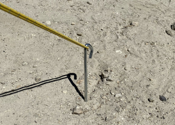 This photo shows a guyline attached to an included stake in the ground.