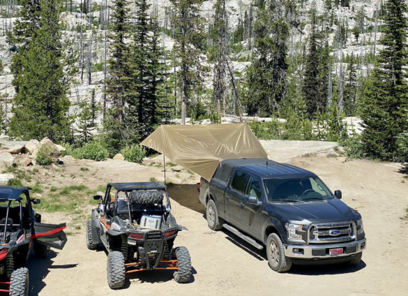 This photo shows a pickup parked at a backcountry site with the SJK Roadhouse Tarp set up.