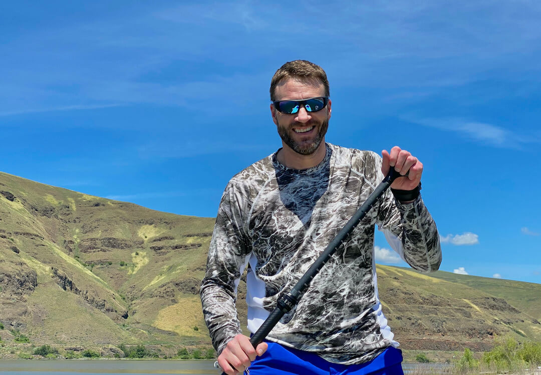 This photo shows the author wearing the new SPY+ Happy Boost sunglasses while stand-up paddleboarding during the testing and review process.