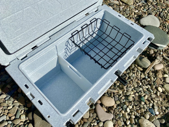This photo shows the interior of the Prospector 103 cooler, with a divider and basket.