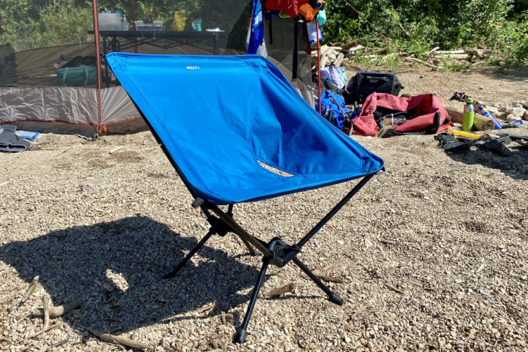 This photo shows the REI Co-op Flexlite Camp Boss Chair outside on a beach during the testing and review process.