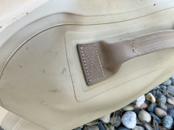 This photo shows a closeup of the outside of the YETI Panga Waterproof Duffel in the tan color option.