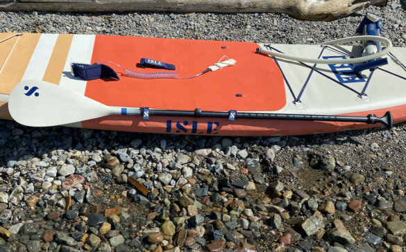 This photo shows the included iSUP paddle attached to the side of the ISLE Pioneer 2.0 Inflatable Paddle Board.