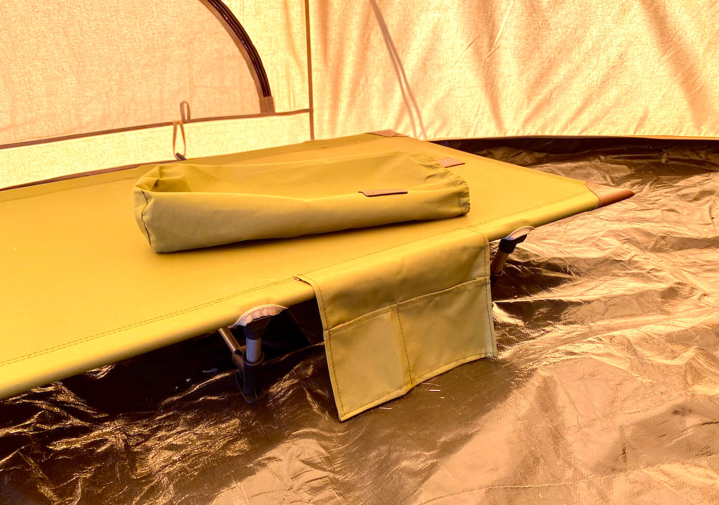 This review photo shows the Kijaro Native Ultralight Cot set up inside of a camping tent.
