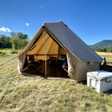 This photo shows the White Duck 16' Regatta Bell Tent setup on a rural meadow during the testing and review process.