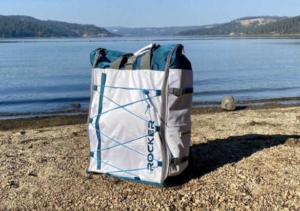 This photo shows the iRocker Cruiser Ultra included backpack on the shore near a lake.