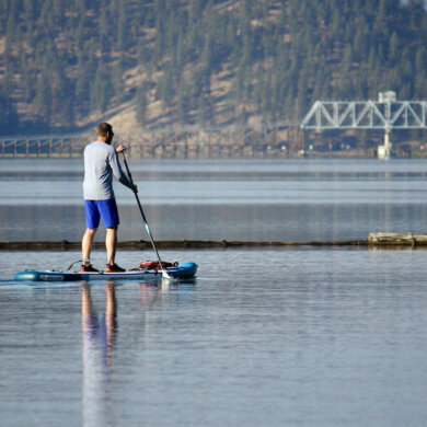 This photo shows the author paddling the iRocker Cruiser Ultra during the testing and review process on a lake.