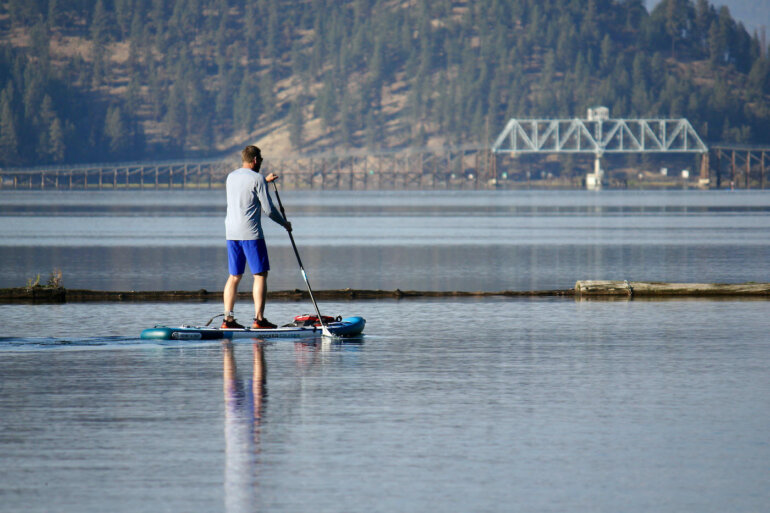 This photo shows the author paddling the iRocker Cruiser Ultra during the testing and review process on a lake.