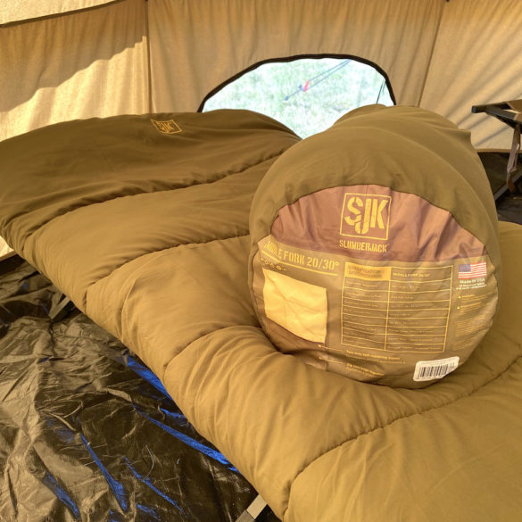 This photo shows the SJK Middle Fork 20/30 Sleeping Bag on a cot inside of a tent.