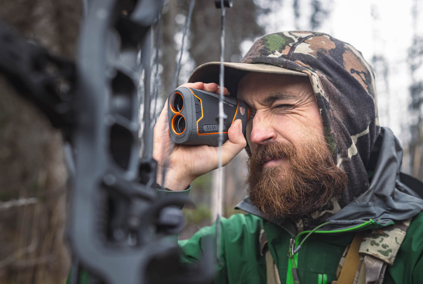 This photo shows an archery hunter using the Maven CRF.1 Rangefinder.