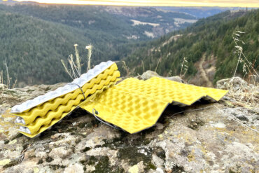 This photo shows two Therm-a-Rest Z Seat foam pads on a rock near a cliff during the testing and review process.