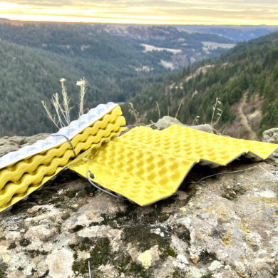 This photo shows two Therm-a-Rest Z Seat foam pads on a rock near a cliff during the testing and review process.