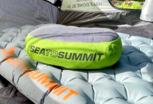 This photo shows the Sea to Summit Aeros Premium Pillow on a sleeping pad inside of a tent.