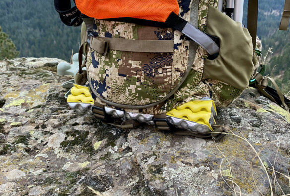 This photo shows a folded up Therm-a-Rest Z Seat attached to the bottom of a hunting backpack.
