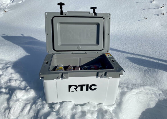 This photo shows the RTIC 32 QT Ultra-Light Cooler with its lid open with food and drink inside.
