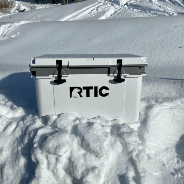 This review photo shows the RTIC 32 QT Ultra-Light Cooler outside on a snow bank during the testing and review process.