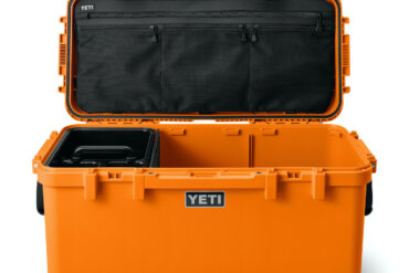 This photo shows the new YETI LoadOut GoBox 60 in the orange color option with its lid open.