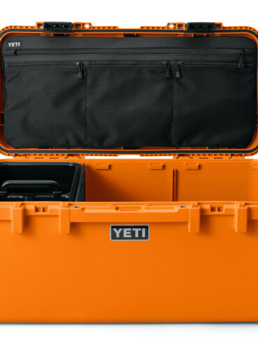This photo shows the new YETI LoadOut GoBox 60 in the orange color option with its lid open.