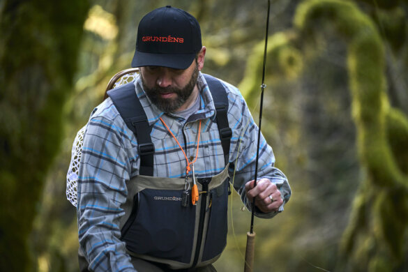 This photo shows a fly fisherman with a fly rod while wearing the Grundens Boundary Zip Stockingfoot Waders.