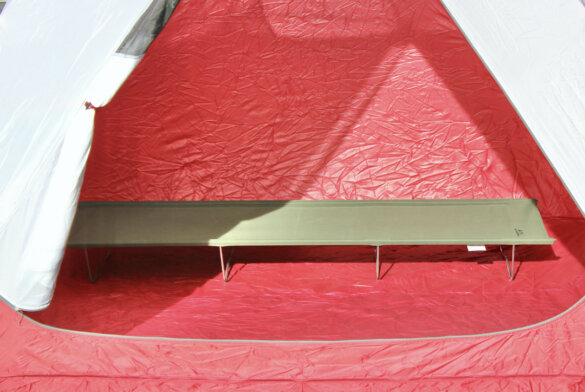 This photo shows the ALPS Mountaineering Lightweight Cot set up inside of a camping tent.