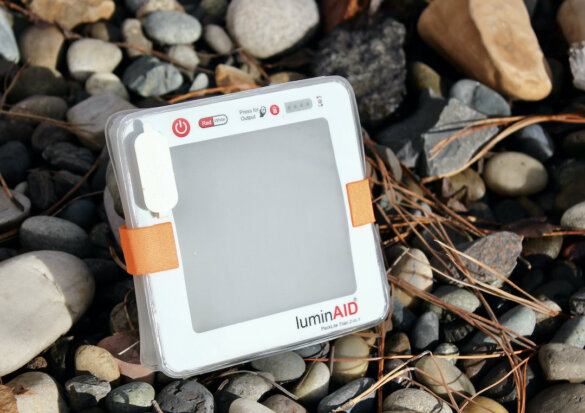 This photo shows the LuminAid PackLite Titan 2-in-1 Solar Lantern Charger charging in the sun.