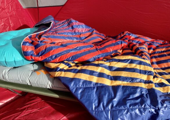 This photo shows the 2-person Rumpl Original Puffy Blanket in the 'Deepwater Rays' color option. 
