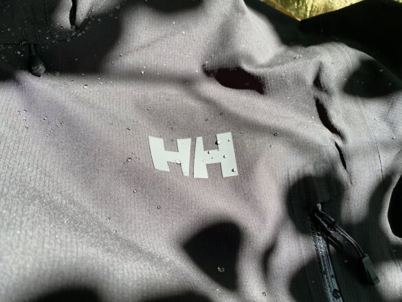 This photo shows a closeup of the Helly Hansen Verglas Infinity Shell Jacket with water droplets on it.