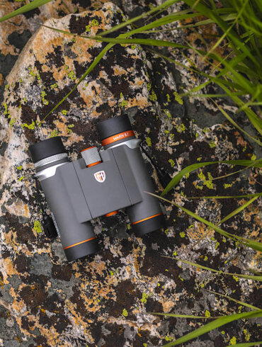 This photo shows the new Maven B.7 Binocular on a rock outside.