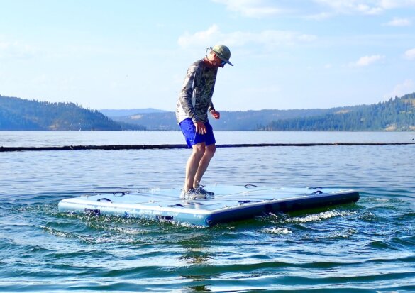 In this photo the author stands on the ISLE Base Camp Dock inflatable swim dock during the testing and review process.