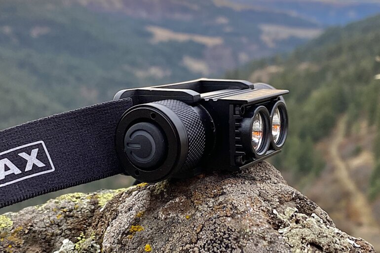 This review photo shows the PEAX Backcountry Duo Headlamp outside on a rock after testing on a pre-dawn hunt.