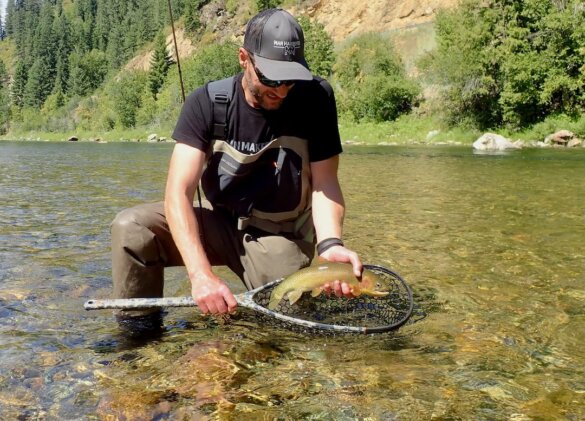 This photo shows the author with a trout he caught while fly fishing in the Grundéns Boundary Stockingfoot Waders during the review process.