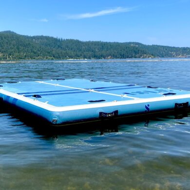 This photo shows the ISLE Base Camp Dock inflated and floating on a lake during the testing and review process.